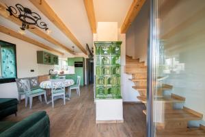 a living room with a staircase and a dining room at Tu Jest Pięknie in Ropa