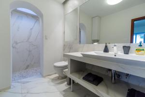 a white bathroom with a sink and a toilet at Villa Bellavista I in Portorož +32 photos