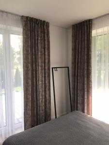 a bedroom with a bed and a large window at J4 apartment with terrace in Palanga
