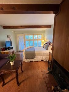 a bedroom with a bed and a fireplace at Carmel Garden Inn in Carmel