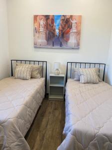 two beds sitting next to each other in a room at San Giuliani Heights in St. Julianʼs