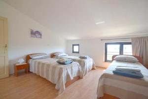 a room with three beds and a window at Panorama Punta in Umag