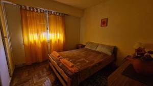 a bedroom with a bed in a room with a window at Depto 2 amb dependencia !! muy luminoso a metros de la playa !! in Mar del Plata