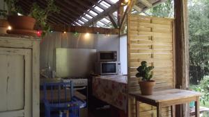 a kitchen with a refrigerator and a table with a table sidx sidx at L'Atelier des Résiniers in Pontenx-les-Forges