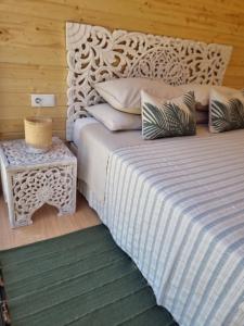 a bedroom with a large white bed with a table at Eco Lodge Villa das Alfarrobas com Piscina in Algoz