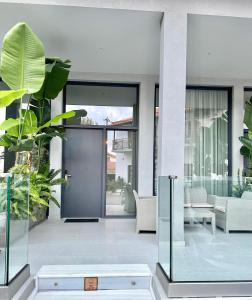 a pivot door in a house with plants at Hotel Alex in Methoni