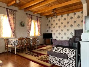 a living room with a couch and a table at Жемчужина in Chok-Tal