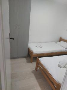 a small room with two beds and a closet at Ranč Andrić in Bajina Bašta +9 photos