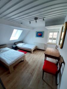 a room with two beds and a table in it at Altstadthaus Günzburg in Günzburg