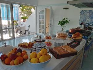a kitchen counter with many bowls of fruits and pastries at La Pergola del Torchio in Ischia