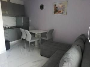 a living room with a couch and a table and chairs at Apartman Čarija 2 in Trogir