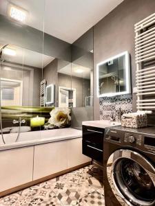 a bathroom with a washer and a washing machine at Stylish apartment in City Centre in Krakow