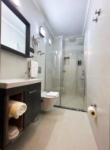 a bathroom with a shower and a toilet and a sink at 01 Nova Otel in Didim