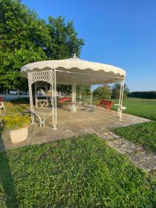 a gazebo with a table and benches in a park at Tra campagna e mare in Lido delle Nazioni
