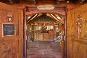 a wooden trolley car in a room with wooden walls at Landhotel Brauner Hirsch in Kammerforst