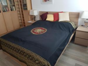 a bedroom with a large bed with a blue comforter at Large private apartment with garden view, terrace and free parking in Bratislava