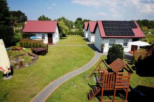 a house with solar panels on top of it at Domki Oliwia in Łeba