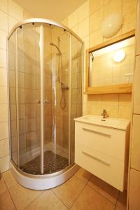 a bathroom with a shower and a sink at Domki Oliwia in Łeba +55 photos