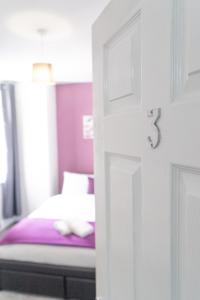 a bedroom with a bed and a white door with a drawer at MMR Homes in Carlisle