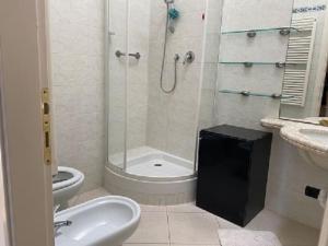 a bathroom with a shower and a toilet and a sink at Casa Roma Arenzano in Arenzano