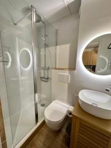 a bathroom with a shower and a toilet and a sink at Somptueux studio de 17m2 Bernex in Bernex