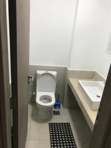 a small bathroom with a toilet and a sink at Swanlake north coast in Zāwiyat al ‘Awwāmah