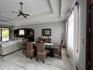 a dining room with a table and chairs and a bed at Casa Famari at Playa Bejuco in Bejuco