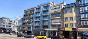a yellow car parked in front of a building at Koksijde Penthouse in Koksijde