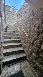 a set of stone stairs with a stone wall at Guest House Suzana in Omišalj