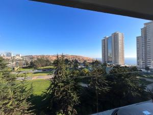 a view of the city from the balcony of a building at Hermoso Depto para 4 personas ,con Arcade de juegos y vista hacia las Dunas y el Mar in Concón