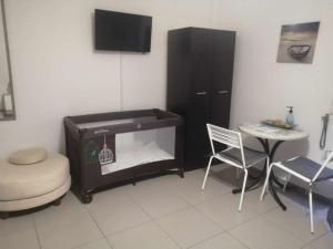 a living room with a stove and a table and chairs at Holiday and Business Home in Áyios Vasílios