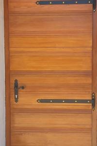 a brown wooden door with a black handle at Stone House Mate in Rovinjsko Selo