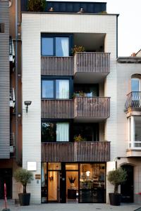 a building with balconies on the side of it at Suite Aux Anges in Antwerp