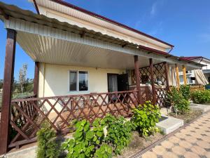 a house with a wooden railing on a porch at Ailus in Chok-Tal