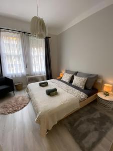 a bedroom with a large bed with two pillows on it at Larix apartman in Budapest