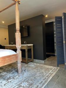 a bedroom with a bed and a table with a mirror at 12 Calderbank in Potchefstroom