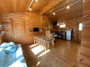 a dining room and kitchen in a log cabin at Sunny Side Cottage in Shimoda +88 photos