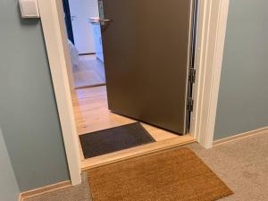 an open door with a door mat in a room at Central 1 bedroom apartment NB!! Small room in Oslo