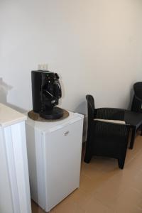 a camera sitting on top of a dresser next to a chair at Ce sta 'o mar for in Naples +20 photos