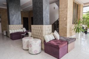 a lobby with two couches and tables and plants at Polina Beach in Sozopol