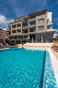 a large swimming pool in front of a building at Polina Beach in Sozopol