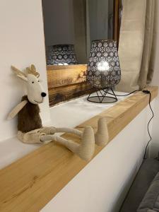 a stuffed animal sitting on a shelf with a mirror at Le Cowsy in Abondance