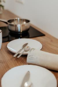 a wooden table with a plate and a pair of scissors at AuerHias in St. Wolfgang