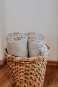 a basket filled with towels on a wooden floor at AuerHias in St. Wolfgang