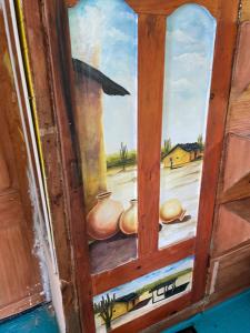 a painting of a window with three pots at Princesa del Mar in Playa Blanca