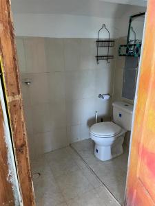 a bathroom with a white toilet in a room at Princesa del Mar in Playa Blanca