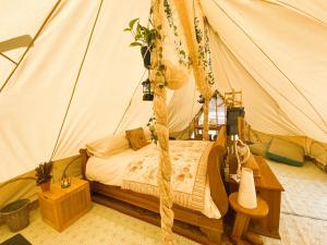 Hope Cottage Bell Tent Retreat tesisinde bir odada yatak veya yataklar