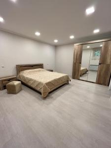 a bedroom with a bed and a large mirror at Green Park Guest House in Dilijan