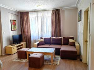 a living room with a couch and a table at Venice Apartments in Sofia