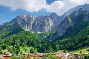 a village in a valley with mountains in the background at Happy Guest Apartments - Alpin Vista Colere in Colere